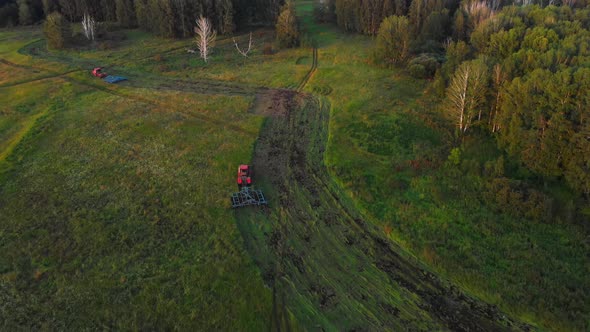 Red tractor with plow