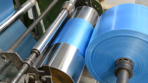 Polyethylene machine makes plastic bags in a plastic bag factory, polyethylene is wound on a bobbin