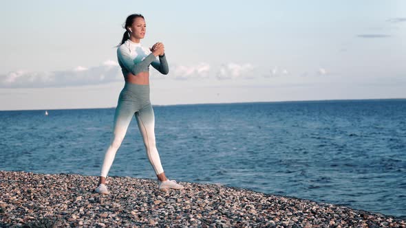 Athletic Woman Training on Beach Performing Squat Enjoying Healthy Lifestyle Physical Activity