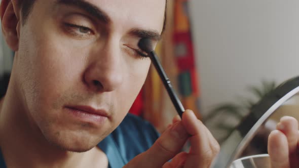 Young Transgender Man Applying Eyeshadow with Brush