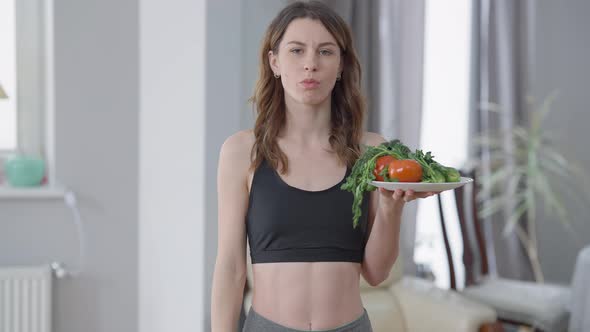 Sad Slim Woman Eating Healthful Vegan Food Sighing Looking at Camera with Upset Facial Expression