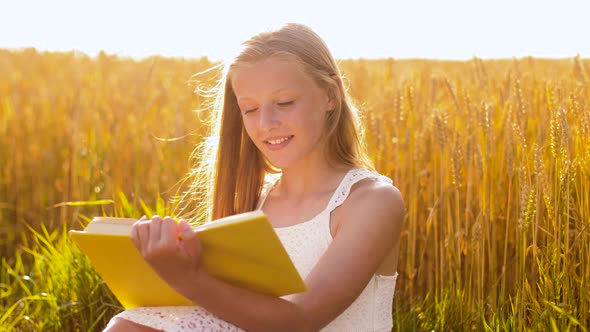 Smiling Young Girl Reading Book on Cereal Field