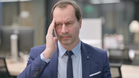 Portrait of Businessman Having Headache