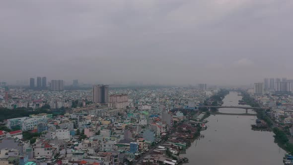 Early foggy,smoggy morning drone footage over canal revealing city skyline and urban waterfront area