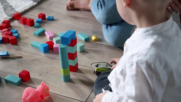 Close Up of Little Cute Boy That Plays with Toys at Home