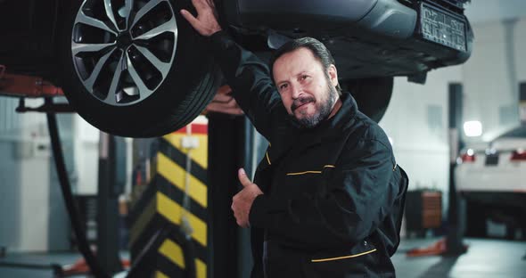 Charismatic Mature Car Mechanic in a Uniform in