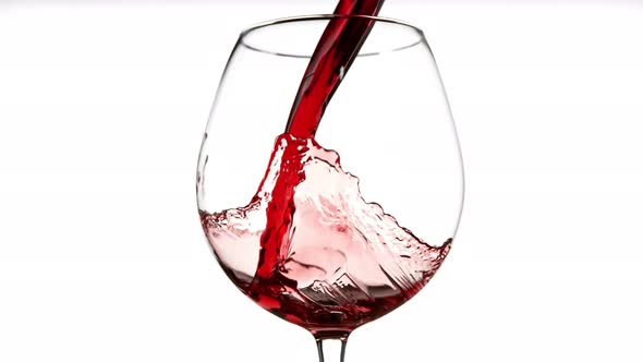 Super Slow Motion Detail Shot of Pouring Red Wine Isolated on White Background at 1000Fps