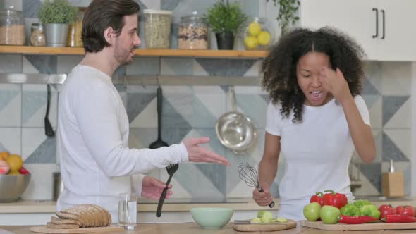 Mixed Race Couple Dancing in Kitchen