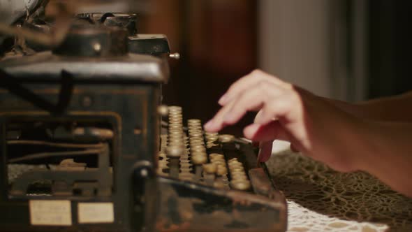 Hands Writing on Old Typewriter Over Wooden Table Background