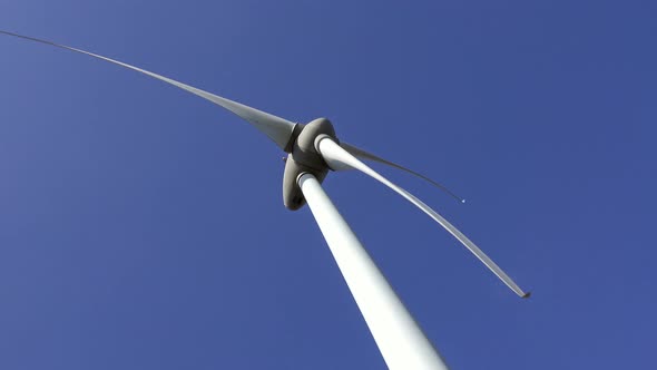 Windmill or Wind Turbine on Wind Farm in Rotation