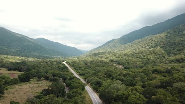 Aerial View of the Green Plains in Mountains and Trafic Road, Tanzania, Africa. The the Green Hills