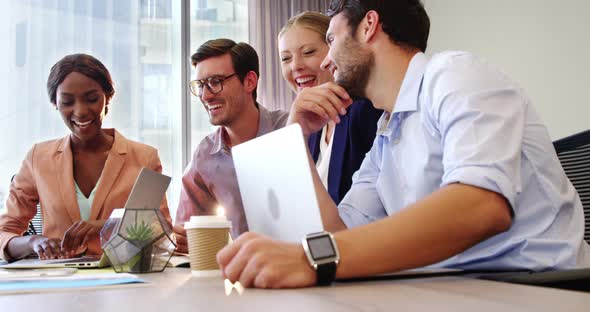 Businesspeople interacting and giving high five to each other