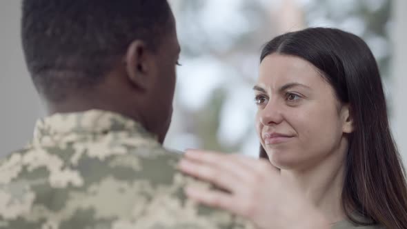 Closeup of Charming Loving Caucasian Woman and Affectionate African American Man in Military Uniform