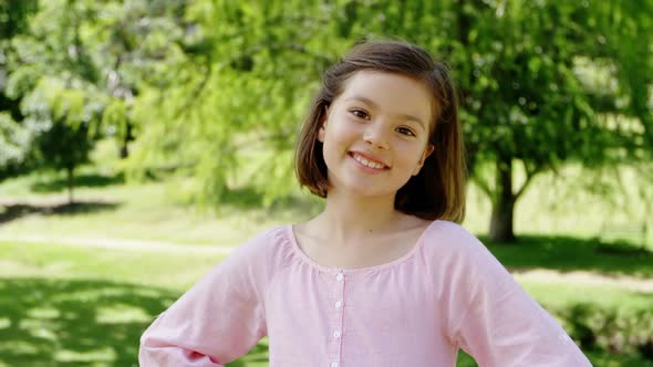 Smiling girl standing in the park