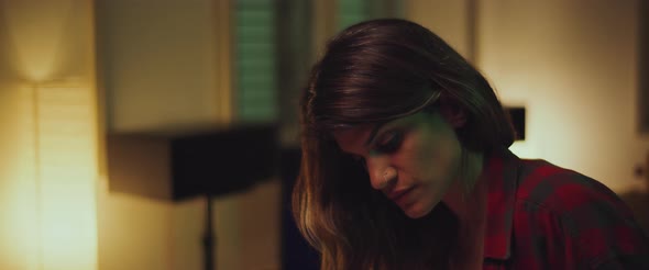 Close up of a young female student studying at home in the evening