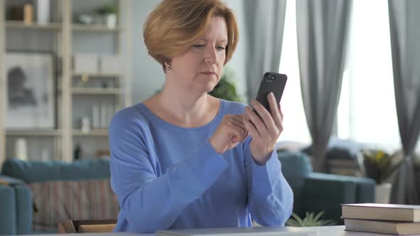 Old Senior Woman Text Messaging on Smartphone