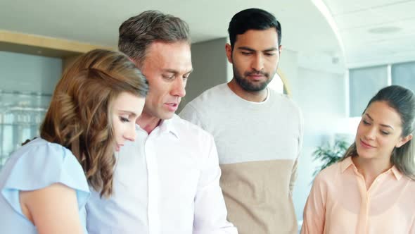 Business people working together on digital tablet in a modern office 4k