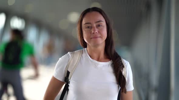 Close-up Portrait of a Smiling, Dark-haired, Middle-aged Woman, She Is in a Public Closed Place