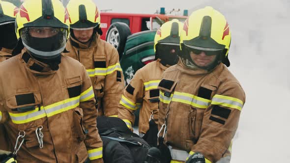 Firefighters Rescuing Injured Person After the Car Accident. Slow Motion