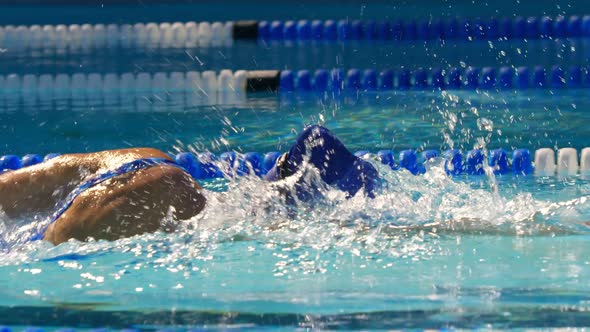 Young female swimmer swimming inside pool 4k