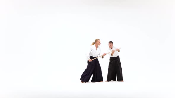 Two Men in Kimono Performing Aikido Using Bokken. Isolated, White.