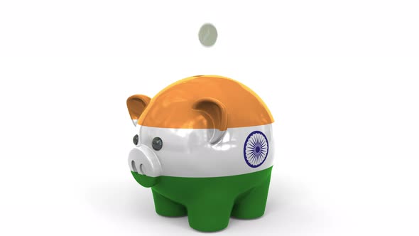 Coins Fall Into Piggy Bank Painted with Flag of India