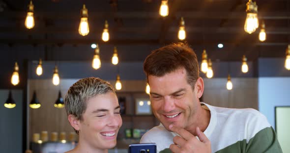 Executive discussing on mobile phone in office cafeteria 4k