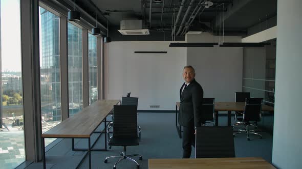 Happy Team of Businessmen and Businesswoman Moving To New Office, with Boxes, Smiling.