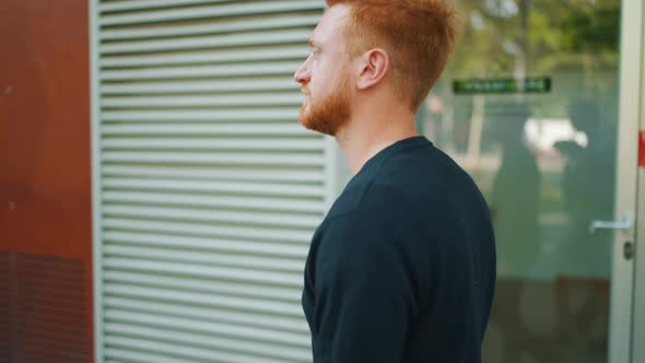 Concentrated red haired man walking