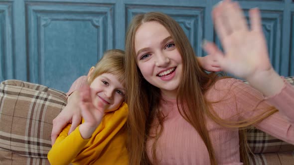 Child Kid Daughter with Mother Embracing Waving Hands to Camera Doing Hello Welcome or Bye Gesture