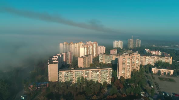 Aerial Drone Footage of Flying Over the City in Fog During Dawn