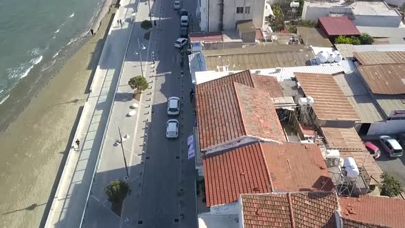 Tilt Up shot Revealing Mackenzie Street Located On Stunning Clear Sea , Larnaca City, Cyprus