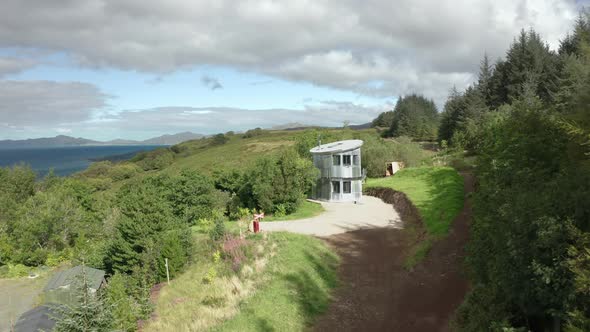 AERIAL - establishing shot of a quirky aluminum house in Scotland