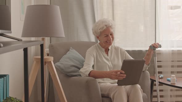 Cheerful Old Lady Video Chatting on Digital Tablet