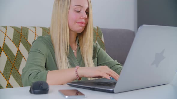 Professional freelancer woman typing text on laptop at home during lockdown