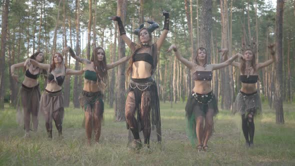 Group of Women Dancers with Make-up and in Mystical Fabulous Costumes Dancing Groovy Dance in the