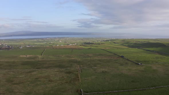 Aerial View of Irish Green Rural Fields During a Summer Sunset in Ireland