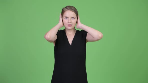 Young Beautiful Businesswoman Covering Ears As Three Wise Monkeys Concept