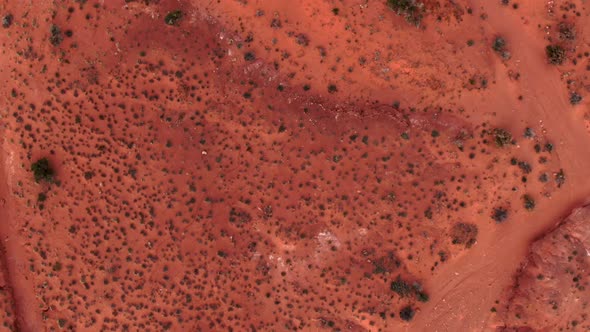 Drone flying looking strait down at the martian looking terrain of Monument Valley