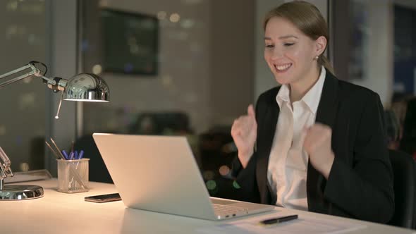 Successful Businesswoman Celebrating on Office Table at Night 