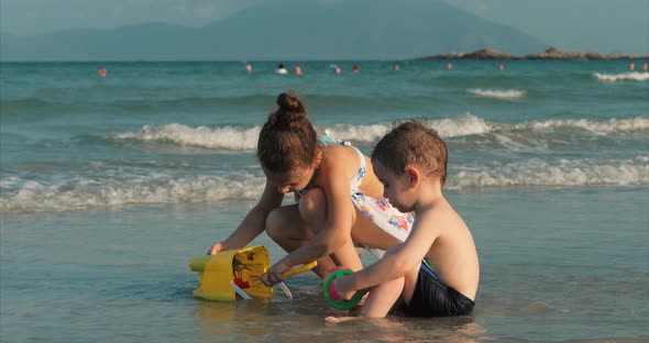 Happy and Carefree Children Playing By the Sea with Sand . Children Playing, Brother and Sister Play