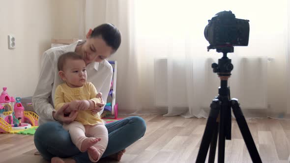 Young Mother with Little Boy Recording Video on Camera and Vlogging About Family and Childhood