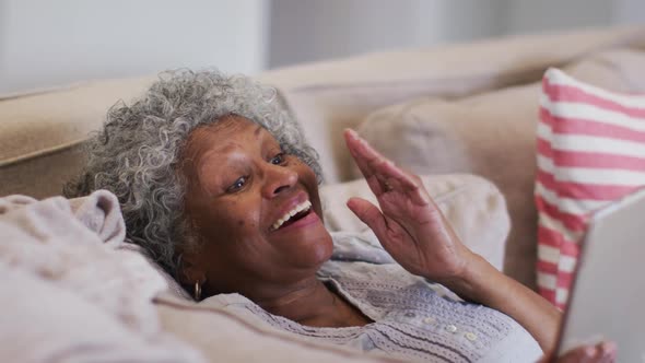 Senior african american woman having a video call on digital tablet at home