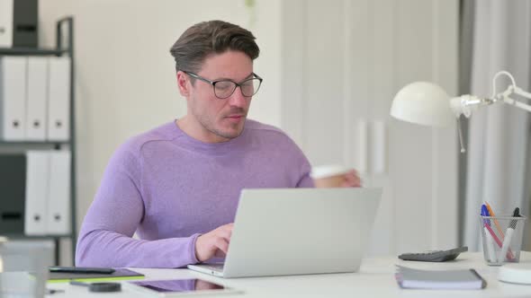 Middle Aged Man Drinking Coffee Having Toothache at Work