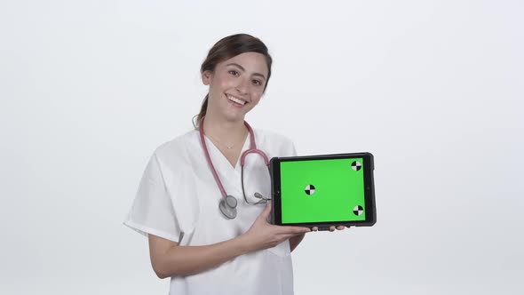 Young woman medical personnel smiling showing results on tablet