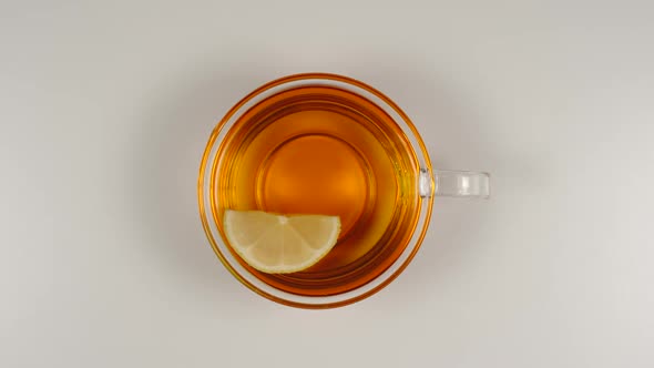 Lemon Slice Swims In A Black Tea In A Glass Tea Cup On A Table