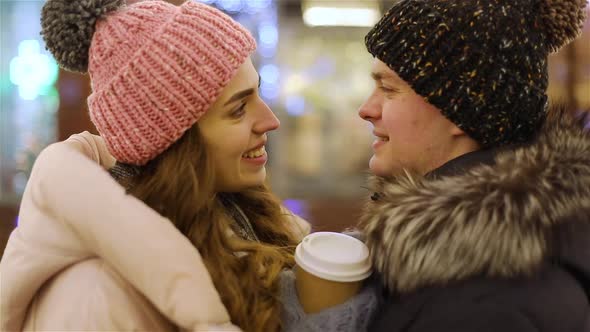 Young Couple Hugging on Street in Winter