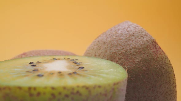 Fresh cut kiwi against yellow background