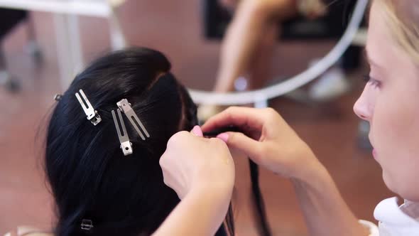 Working Process of Hairdresser Plaiting Braids to Brunette Girl in Beauty Salon