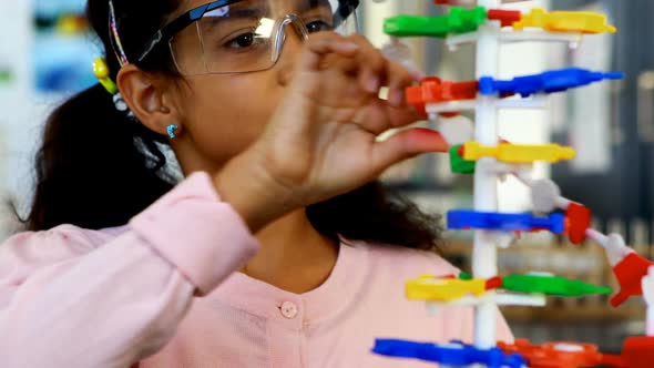 Schoolkid experimenting molecule model in laboratory 4k